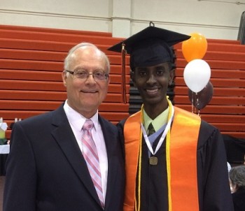 Bakar Ali pictured at a graduation ceremony with his mentor Jim Kurt